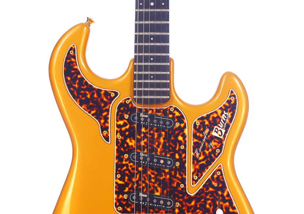 Close-Up Of A Burns Legend 1994 Electric Guitar In Gold, Featuring Three Single-Coil Pickups, Tortoiseshell Pickguards, And The Signature &Quot;Billy&Quot; Near The Bottom Right. The Neck And Part Of The Upper Bout Are Also Visible.