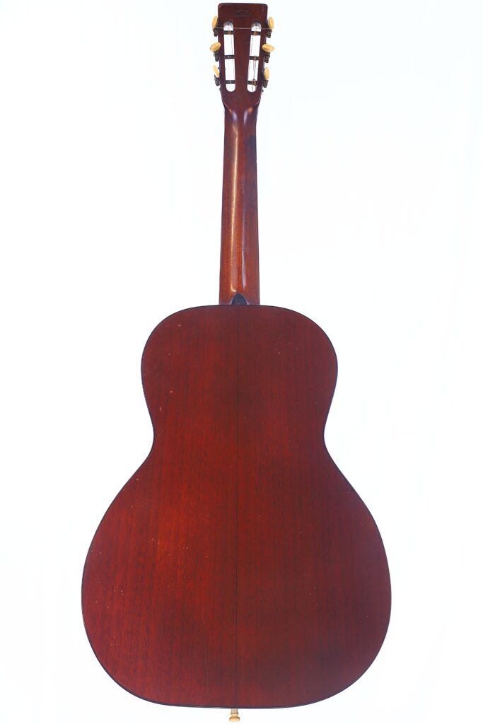 The Image Shows The Back View Of A Martin 0-18 1926 Acoustic Guitar With A Rich, Dark Wooden Finish Against A White Background. The Neck, Body, And Tuning Pegs Of The Guitar Are Visible.
