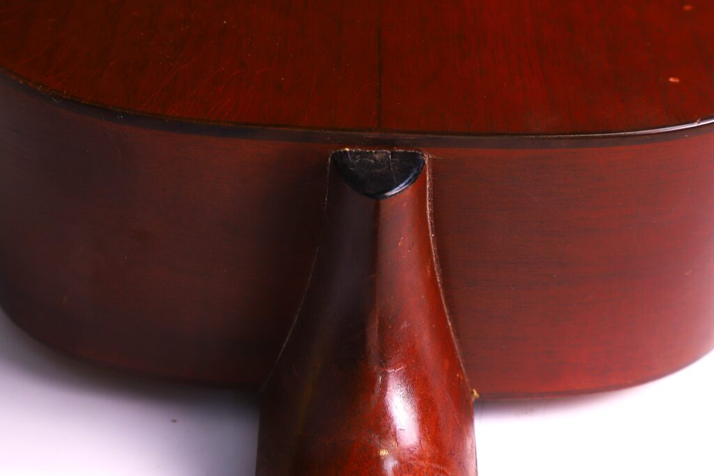 Detailed Look At The Neck Joint Of A Martin 0-18 1926 Acoustic Guitar, Highlighting Where The Neck Meets The Body And Its Glossy Reddish-Brown Finish.
