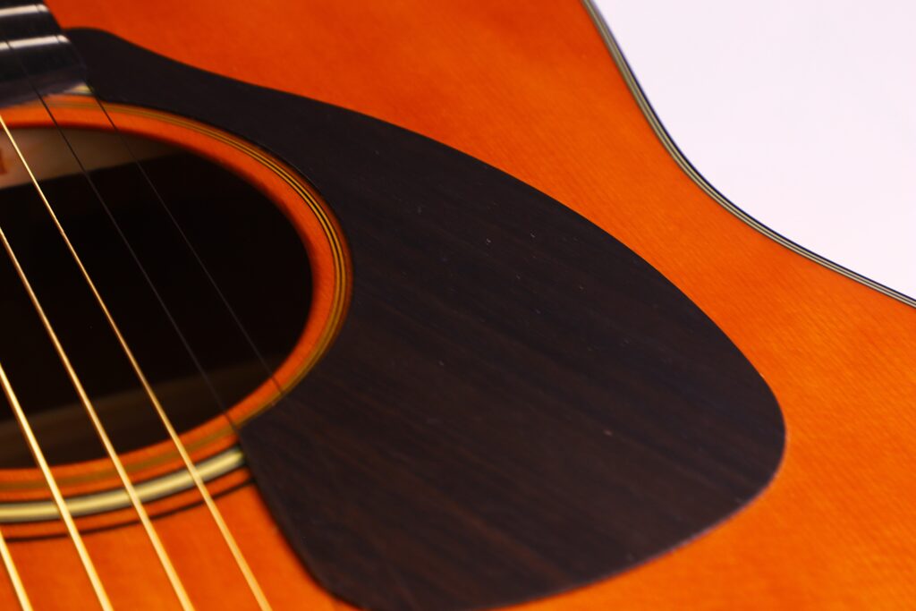 Close-Up Of The Yamaha Fg5 Acoustic Guitar, Highlighting Its Sound Hole, Strings, And Dark Pickguard On A Glossy Wooden Body.