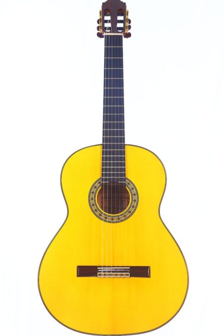 The Hermanos Sanchis Lopez F Especial 2025 Mod. Reyes Flamenco Guitar Features A Natural Wood Finish, Dark Fretboard, And Ornate Rosette Detail Around The Sound Hole, Shown Against A White Background.