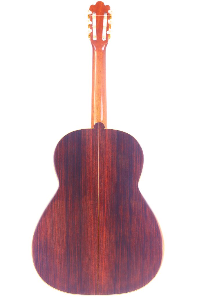 Das Bild Zeigt Die Rückansicht Einer Vicente Tatay Alabau 1920 Klassische Gitarre Mit Einer Holzoberfläche Mit Dunkler Holzmaserung Und Einem Helleren Braunen Hals Und Kopfplatte.