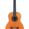 Die Manuel Ordono 2023 Negra Flamenco Gitarre mit Holzkorpus, sechs Saiten, dunklem Griffbrett und dekorativer Rosette um das Schallloch ist vor einem weißen Hintergrund fotografiert. Die Manuel Ordono 2023 Negra Flamenco Gitarre mit Holzkorpus, sechs Saiten, dunklem Griffbrett und dekorativer Rosette um das Schallloch ist vor einem weißen Hintergrund fotografiert.