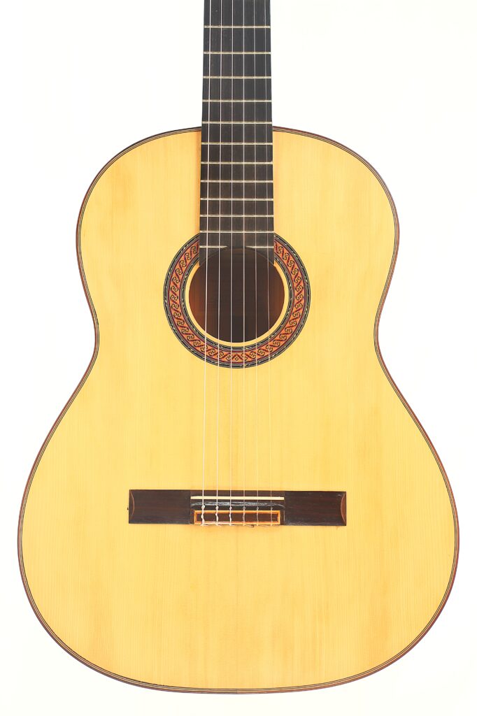 Eine „Hermanos Conde 1988 Faustino Conde Flamenco“-Gitarre mit hellem Korpus, dunklem Griffbrett und einer dekorativen Rosette ist vor weißem Hintergrund abgebildet. Eine „Hermanos Conde 1988 Faustino Conde Flamenco“-Gitarre mit hellem Korpus, dunklem Griffbrett und einer dekorativen Rosette ist vor weißem Hintergrund abgebildet.