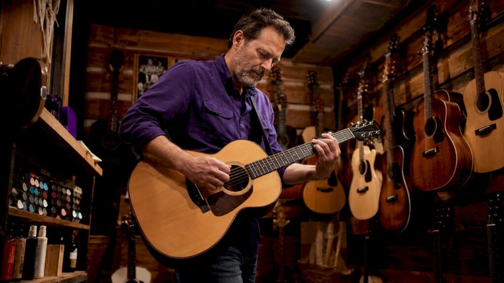 Guitarist playing dreadnought acoustic guitar