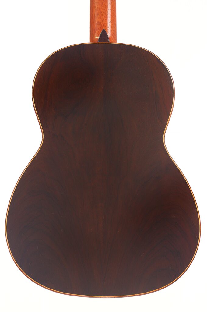Das Bild zeigt die Rückseite einer „Carl Hermann Schäfer – Nicolaus Wollf 2012 Klassische Gitarre“ mit einem satten, dunkelbraunen Holzfinish und hellen Zierleisten an den Rändern. Der hellere Holzhals ist oben teilweise zu sehen. Das Bild zeigt die Rückseite einer „Carl Hermann Schäfer – Nicolaus Wollf 2012 Klassische Gitarre“ mit einem satten, dunkelbraunen Holzfinish und hellen Zierleisten an den Rändern. Der hellere Holzhals ist oben teilweise zu sehen.