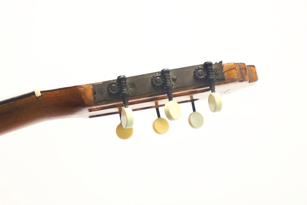 Nahaufnahme der Stimmwirbel am Kopf einer Salvador Ibanez 1900 Klassische Gitarre, mit vier cremefarbenen Knöpfen vor weißem Hintergrund. Nahaufnahme der Stimmwirbel am Kopf einer Salvador Ibanez 1900 Klassische Gitarre, mit vier cremefarbenen Knöpfen vor weißem Hintergrund.