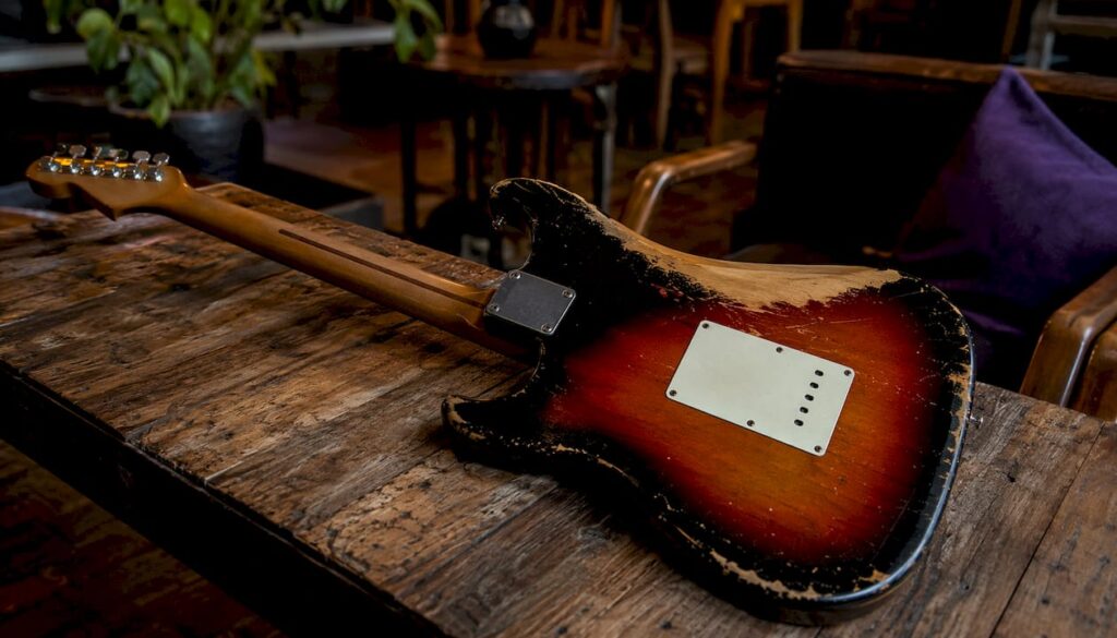Vintage guitar showing finish wear on body and neck
