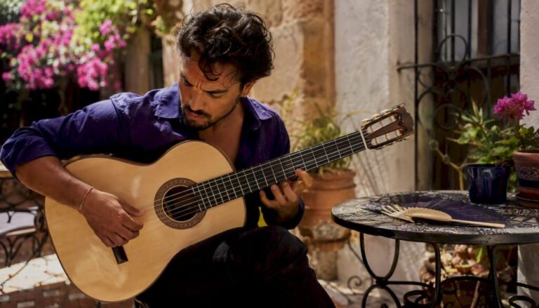 Flamenco guitarist playing cypress wood guitar