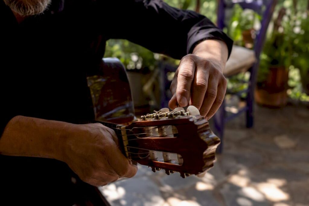 Hands adjusting flamenco guitar strings