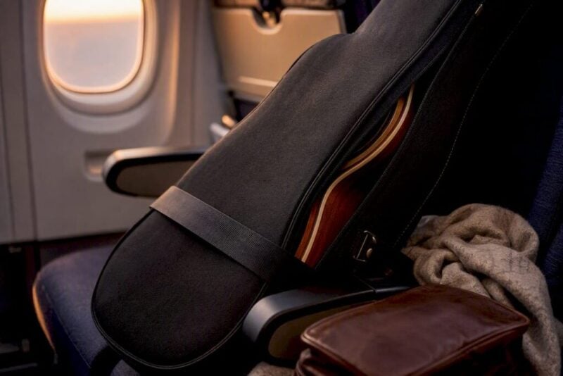 Guitar travel case in airplane seat