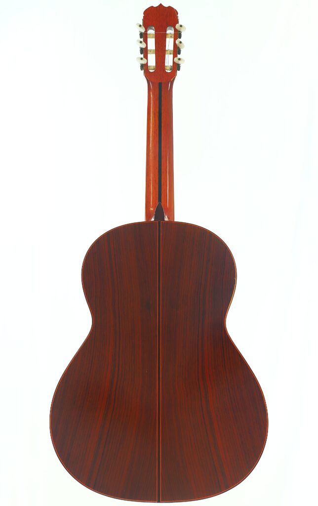 Die Rückansicht der Jose Ramirez 1a 1977 Klassische Gitarre, gefertigt aus dunklem, poliertem Holz mit einer vertikalen Mittelnaht, zeigt den Hals und die Stimmwirbel vor einem weißen Hintergrund. Die Rückansicht der Jose Ramirez 1a 1977 Klassische Gitarre, gefertigt aus dunklem, poliertem Holz mit einer vertikalen Mittelnaht, zeigt den Hals und die Stimmwirbel vor einem weißen Hintergrund.