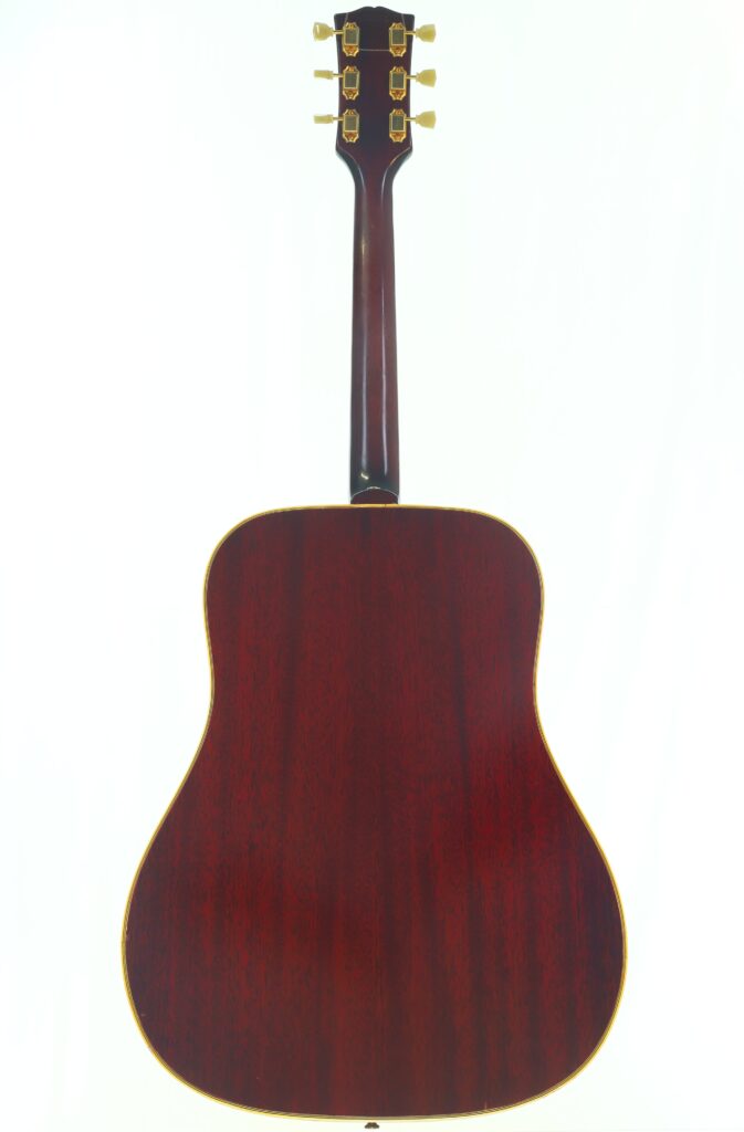 Eine Rückansicht der Gibson SJN 1968 Akustikgitarre mit dunkler Holzoberfläche und goldenen Stimmwirbeln vor einem hellen Hintergrund. Eine Rückansicht der Gibson SJN 1968 Akustikgitarre mit dunkler Holzoberfläche und goldenen Stimmwirbeln vor einem hellen Hintergrund.