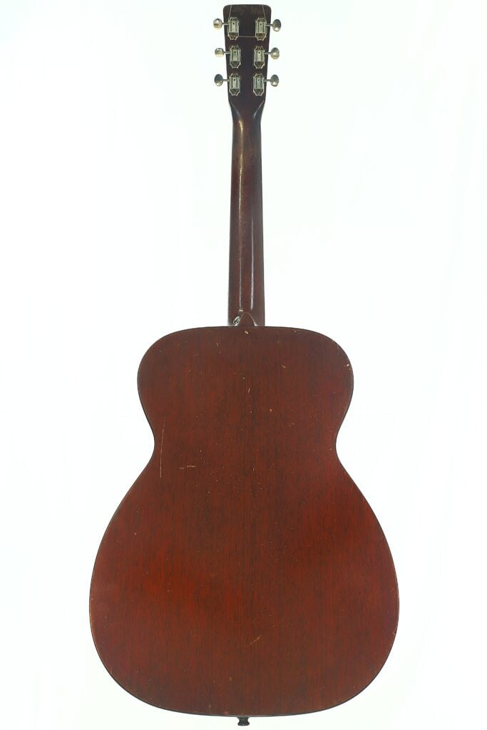Das Bild zeigt die Rückansicht einer Martin 00-18 Akustikgitarre aus dem Jahr 1953 mit einer dunkelbraunen Holzoberfläche, die den Hals, die Stimmwirbel und den elegant geschwungenen Korpus vor einem weißen Hintergrund hervorhebt. Das Bild zeigt die Rückansicht einer Martin 00-18 Akustikgitarre aus dem Jahr 1953 mit einer dunkelbraunen Holzoberfläche, die den Hals, die Stimmwirbel und den elegant geschwungenen Korpus vor einem weißen Hintergrund hervorhebt.