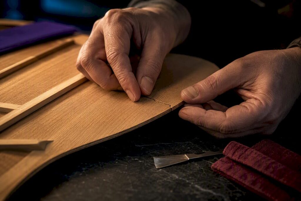 Luthier aligning a fresh guitar crack