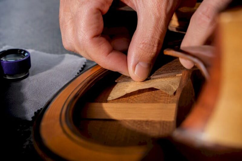 Collector inspecting an anonymous guitar label