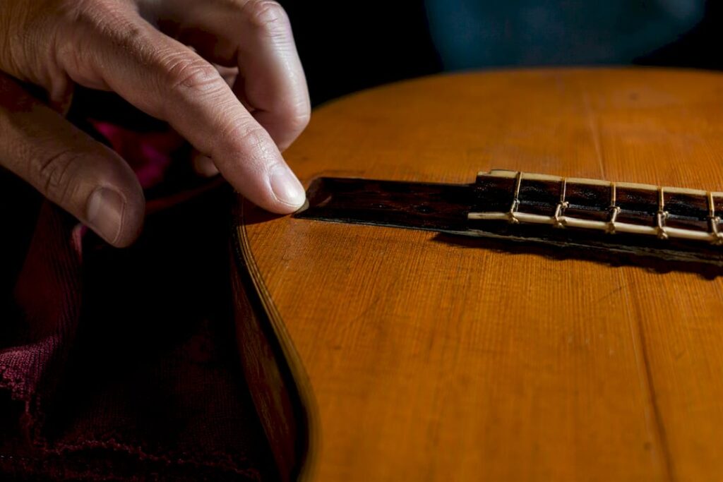 Luthier checking a vintage guitar bridge