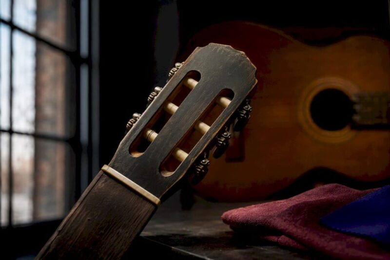 Cropped vintage guitar headstock under inspection