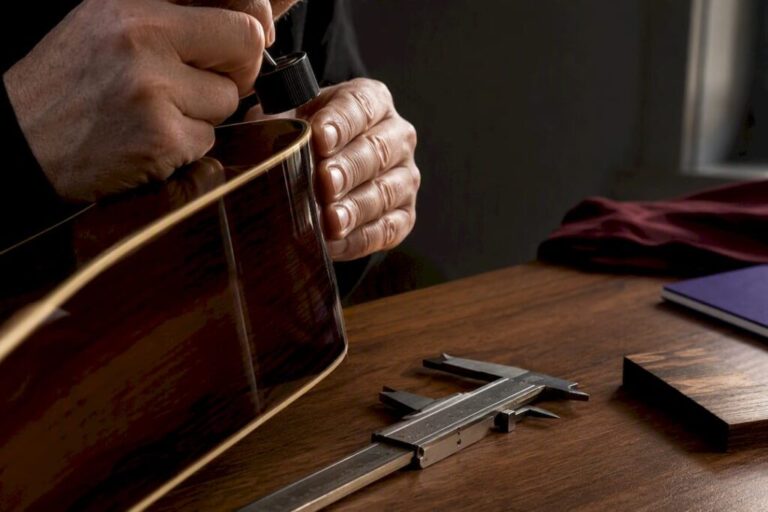 Specialist examining guitar finish with loupe