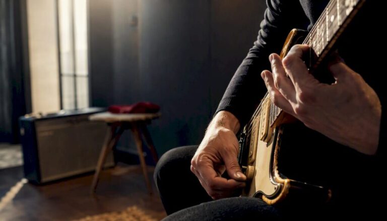Buyer testing a guitar in dealer showroom