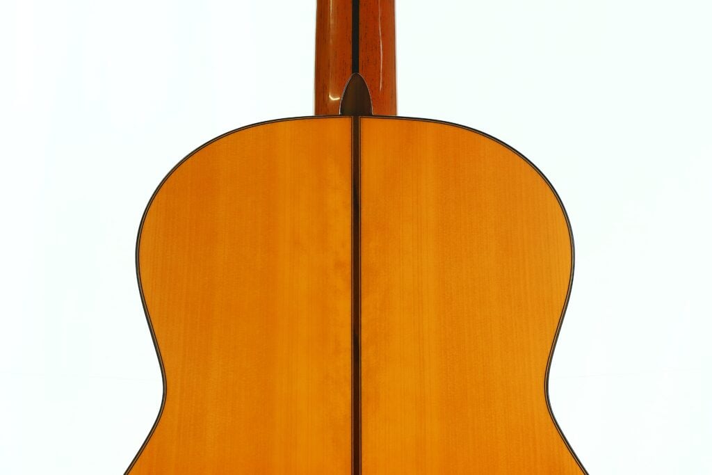 Rückansicht des hellen Holzkörpers und des Halses einer klassischen Akustikgitarre vom Typ Antonio Aparicio Master Flamenco Gitarre. Rückansicht des hellen Holzkörpers und des Halses einer klassischen Akustikgitarre vom Typ Antonio Aparicio Master Flamenco Gitarre.