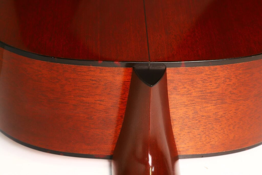 Eine Nahaufnahme der Verbindung zwischen Halsfuß und Korpus einer Martin D-18 VS Akustikgitarre aus dem Jahr 2006. Eine Nahaufnahme der Verbindung zwischen Halsfuß und Korpus einer Martin D-18 VS Akustikgitarre aus dem Jahr 2006.