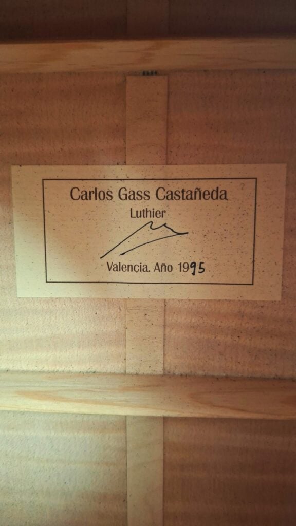 Auf einem rechteckigen Etikett im Inneren der Modell Lacote Romantikgitarre von Carlos Gass Castañeda aus dem Jahr 1995 steht Carlos Gass Castañeda Luthier, gefolgt von einer Unterschrift, Valencia und Año 1995. Auf einem rechteckigen Etikett im Inneren der Modell Lacote Romantikgitarre von Carlos Gass Castañeda aus dem Jahr 1995 steht Carlos Gass Castañeda Luthier, gefolgt von einer Unterschrift, Valencia und Año 1995.